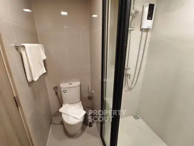 Modern bathroom with sleek shower and toilet design, perfect for contemporary living spaces.
