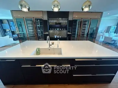 Luxurious modern kitchen with sleek island and open layout, perfect for entertaining.