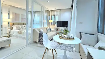 Modern open-plan living room with elegant decor and natural light
