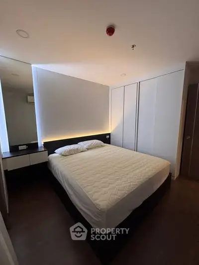 Modern minimalist bedroom with sleek design and ambient lighting