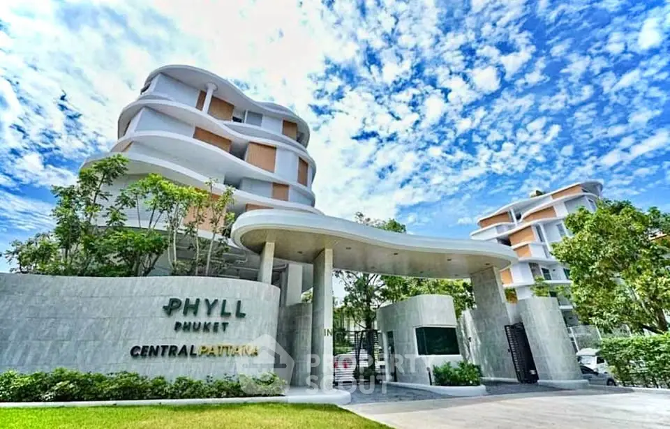 Modern architectural building with lush greenery and clear blue sky in Phuket.