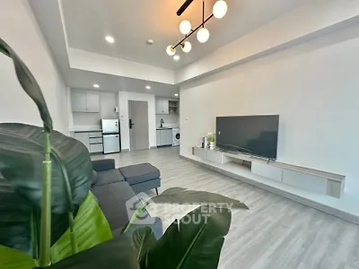 Modern living room with sleek furniture and open kitchen layout