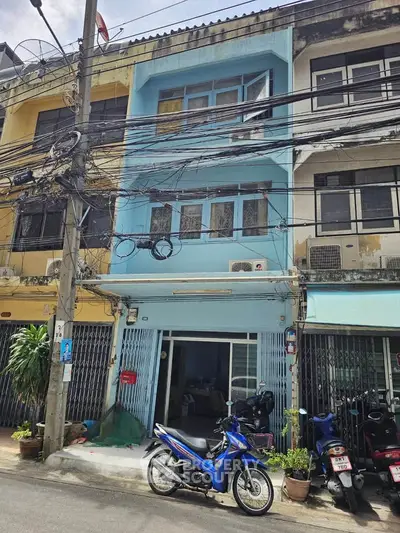 Charming urban townhouse with vibrant facade and street view, perfect for city living.