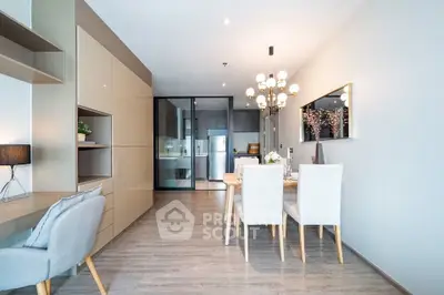 Modern dining area with elegant lighting and open kitchen layout in a stylish apartment.