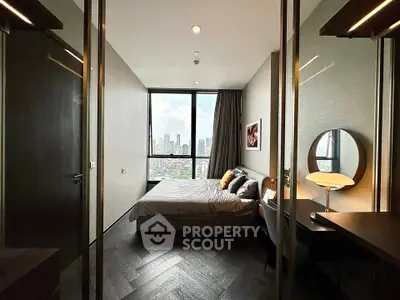 Luxurious bedroom with stunning city view, modern decor, and elegant furnishings in a high-rise apartment.