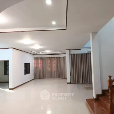 Spacious living room with elegant ceiling lights and large windows