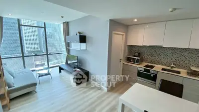 Modern open-plan living room and kitchen with large windows and city view.