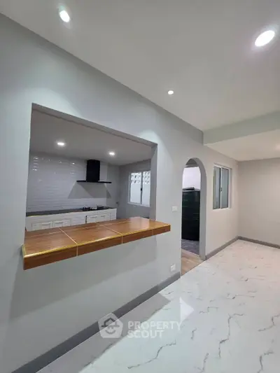 Modern kitchen with open layout and sleek countertops