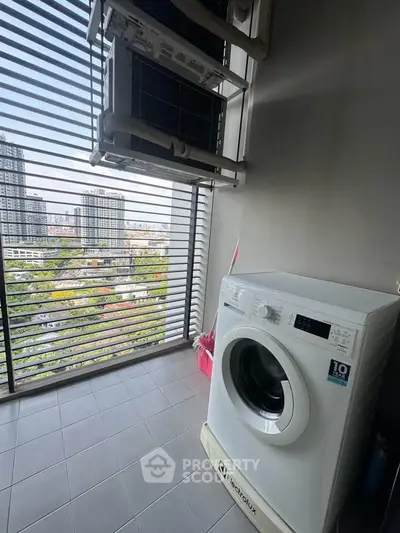 Modern apartment balcony with washing machine and city view