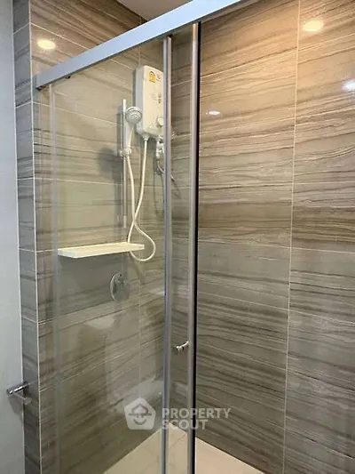 Modern bathroom with glass shower enclosure and sleek tile design