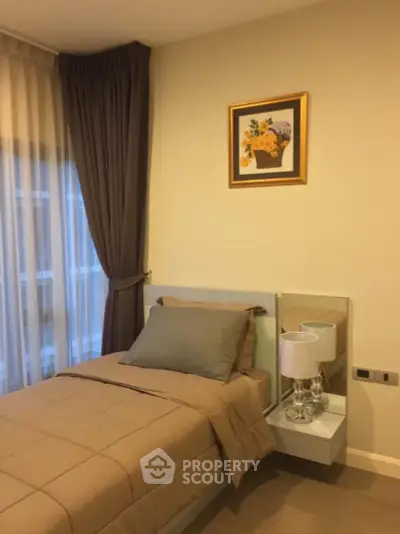Cozy bedroom with elegant decor and natural light, perfect for relaxation.