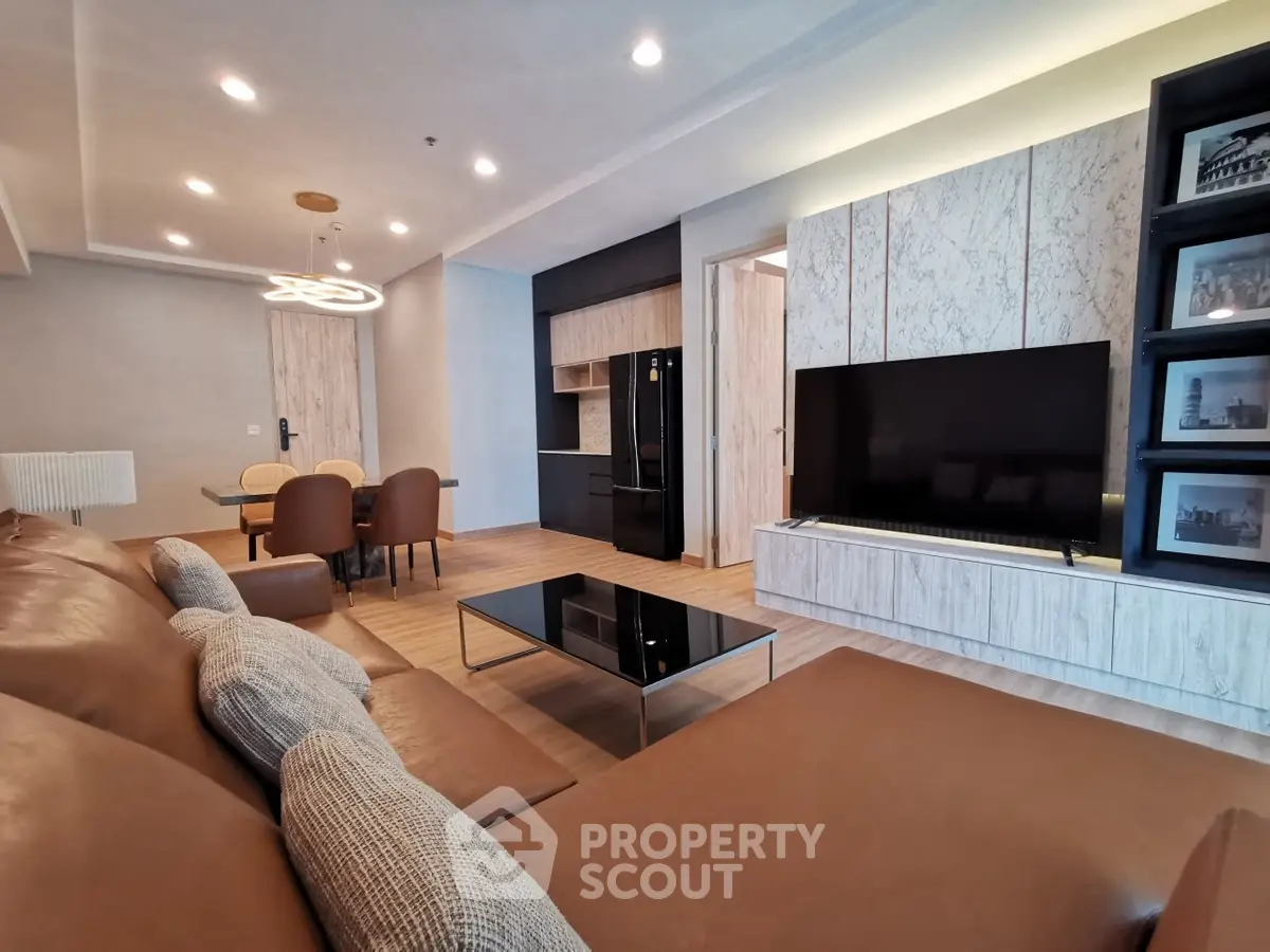 Luxurious modern living room with elegant decor and spacious layout, featuring a sleek TV unit and comfortable seating.