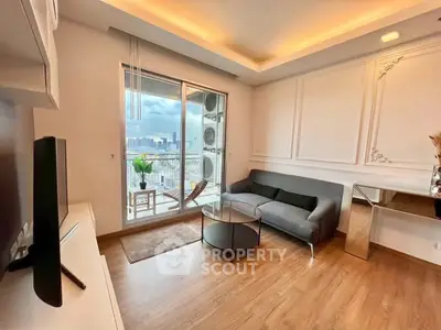 Modern living room with balcony and city view, featuring stylish decor and wooden flooring.