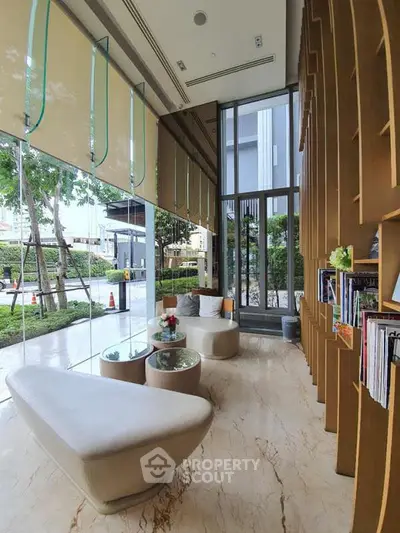 Luxurious modern lobby with elegant seating and floor-to-ceiling windows offering garden views.