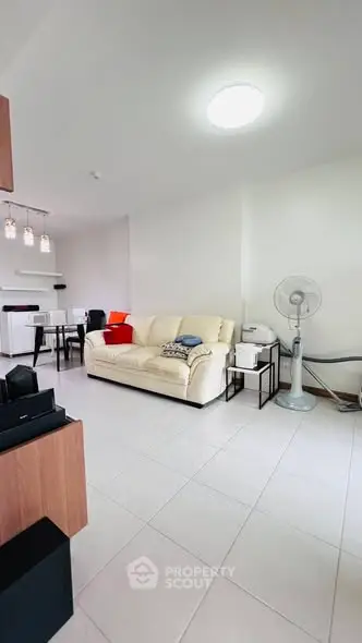 Spacious living room with modern decor and natural lighting, perfect for relaxation and entertainment.