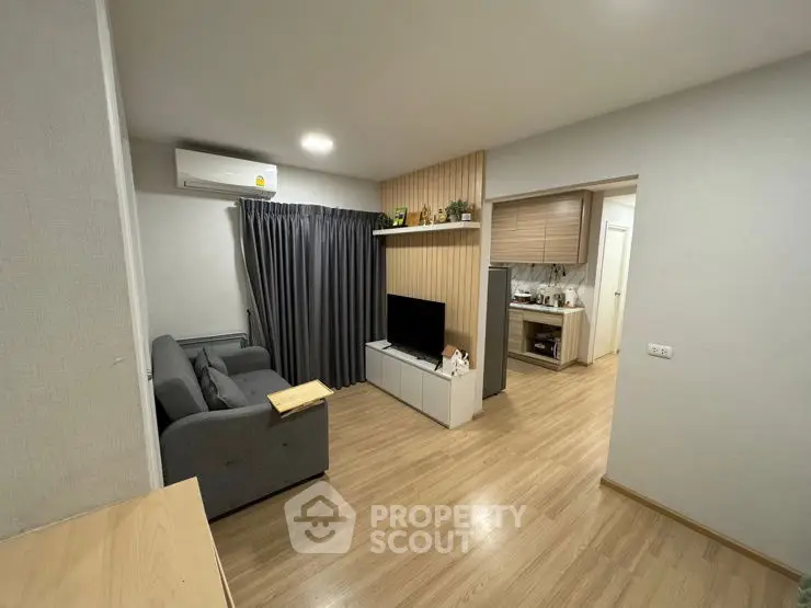 Modern living room with sleek design and open kitchen layout