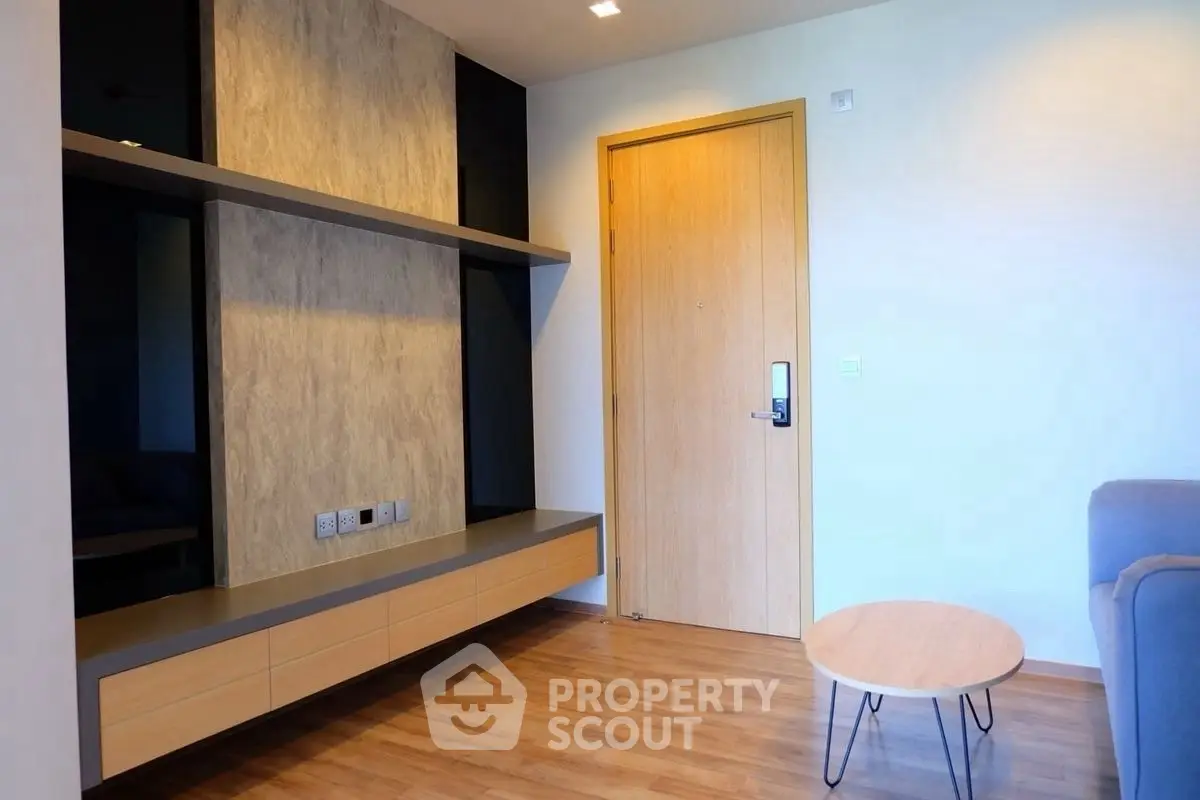 Modern living room with sleek wooden flooring and minimalist furniture design.