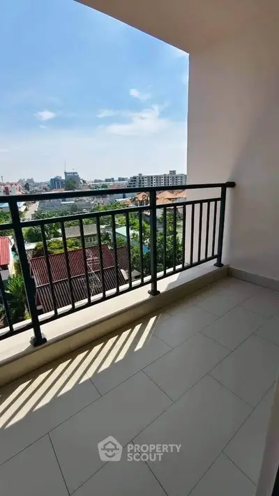 Spacious balcony with city view, perfect for relaxation and enjoying the skyline.