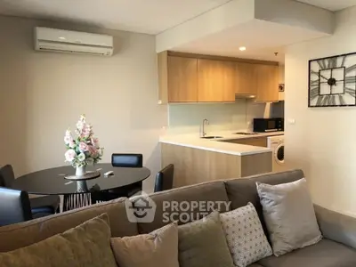 Modern open-plan living room with stylish kitchen and cozy seating area