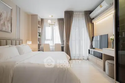 Modern bedroom with elegant decor, large window, and sleek furniture in a stylish apartment.