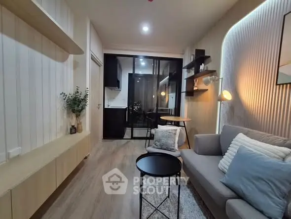 Modern living room with stylish decor and open layout, featuring cozy seating and elegant lighting.