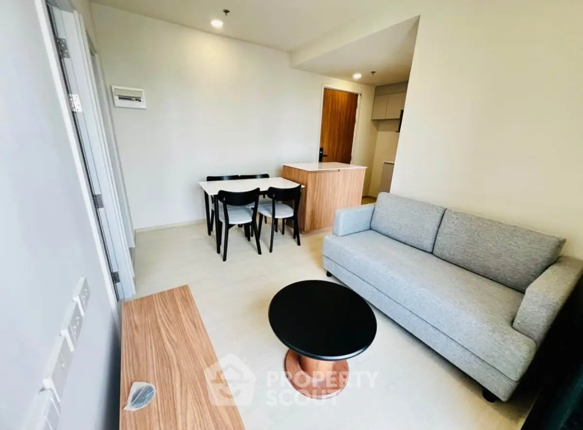 Modern living room with cozy sofa and dining area in stylish apartment