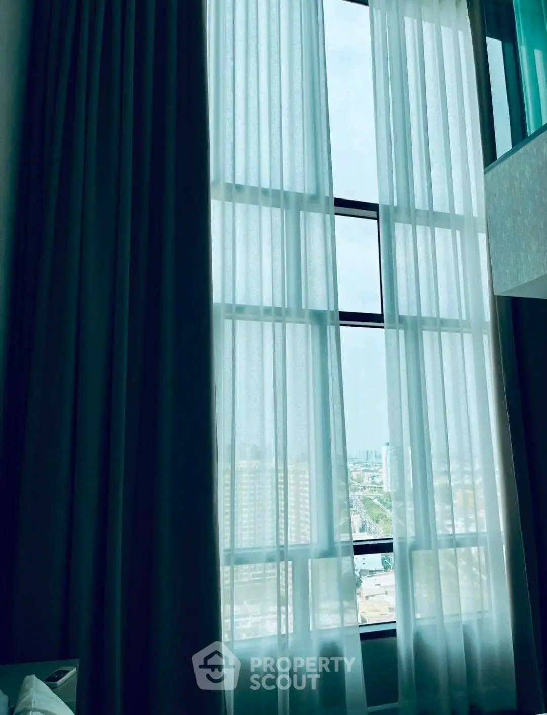 Stunning floor-to-ceiling windows with city view in modern apartment