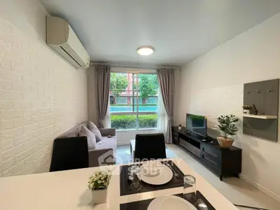 Modern living room with pool view, stylish decor, and cozy ambiance.