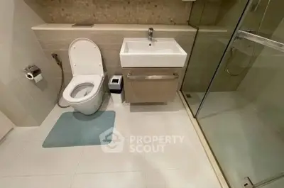Modern bathroom with sleek fixtures and glass shower enclosure