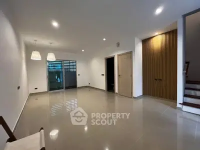Spacious modern living room with elegant lighting and sleek tile flooring