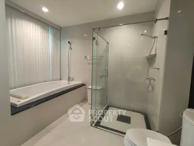 Luxurious modern bathroom with glass shower and large bathtub