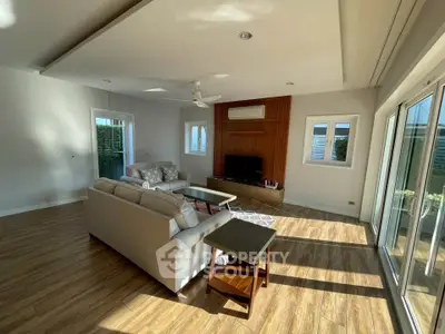 Spacious living room with modern furniture and large windows for natural light.