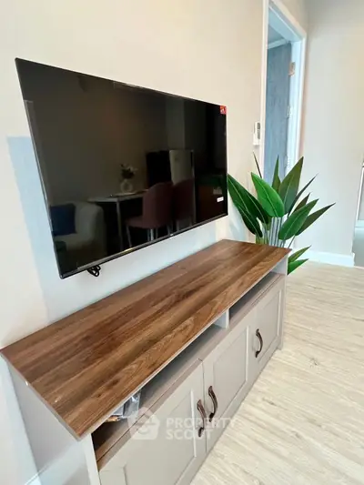 Modern living room with sleek TV stand and wall-mounted flat-screen TV