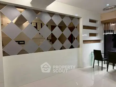 Modern interior with stylish geometric wall design and sleek dining area