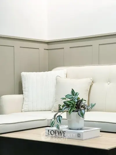 Elegant living room with plush sofa and stylish decor, perfect for modern comfort and relaxation.