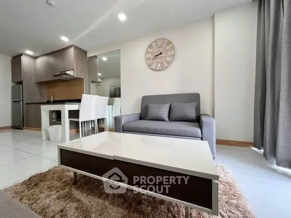 Modern living room with stylish furniture and open kitchen layout