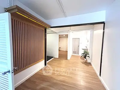 Modern interior hallway with wooden flooring and stylish wall paneling