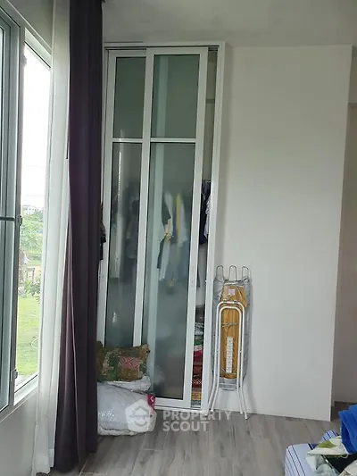 Cozy bedroom corner with wardrobe and window view