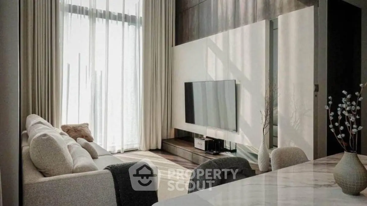 Modern living room with elegant decor and large windows for natural light.