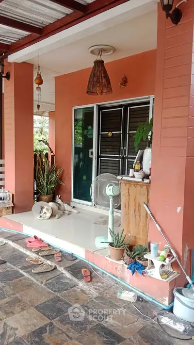 Charming porch with sliding glass doors and cozy decor, perfect for relaxation.