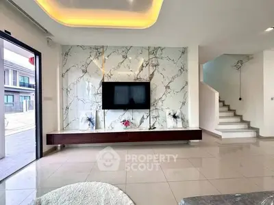 Luxurious modern living room with marble accent wall and sleek TV setup