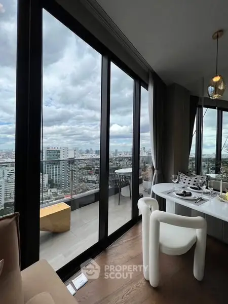 Luxurious high-rise apartment with stunning city view and elegant dining area.