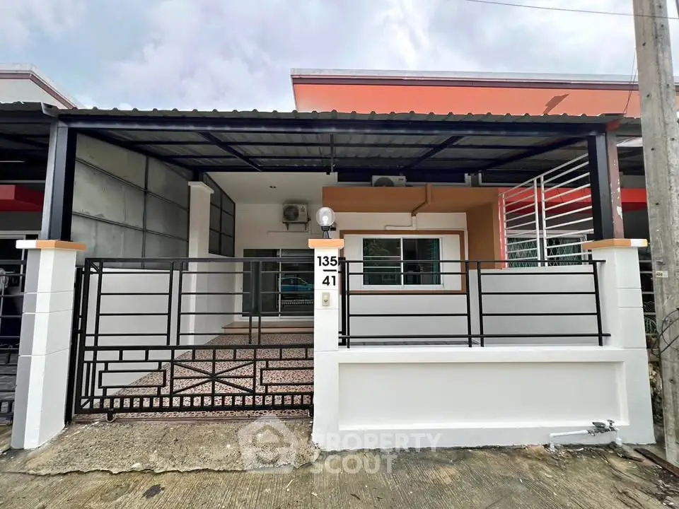 Charming single-story home with modern facade and gated entrance, perfect for family living.