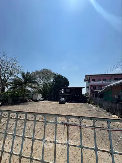 Spacious open lot with potential for development under clear blue skies.