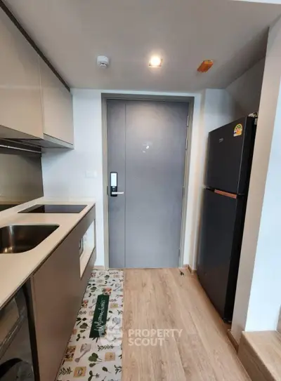 Modern kitchen with sleek appliances and stylish flooring