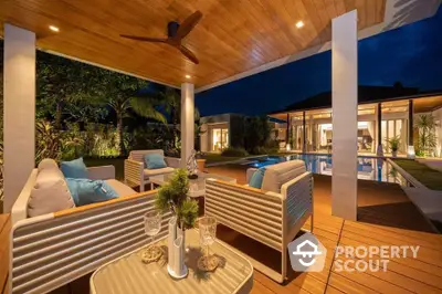 Luxurious outdoor patio with pool view and modern seating at night