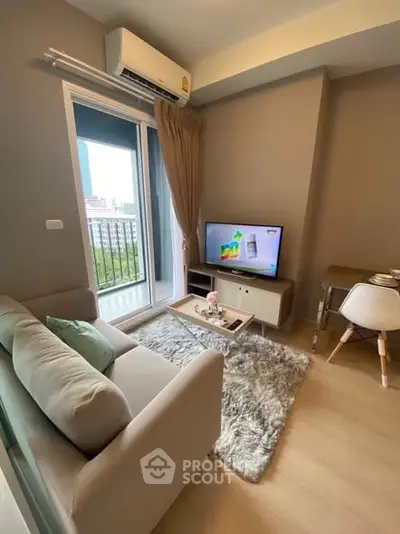 Modern living room with cozy sofa, TV, and city view from window.