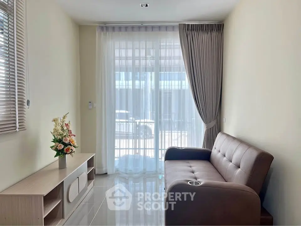 Bright living room with modern sofa and elegant curtains, perfect for relaxation.