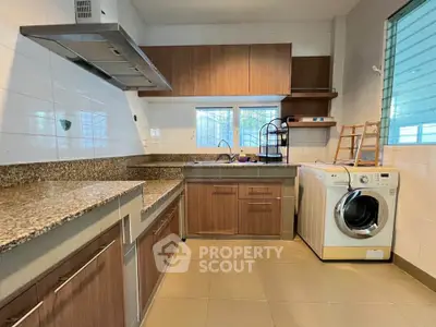 Modern kitchen with granite countertops and built-in washing machine
