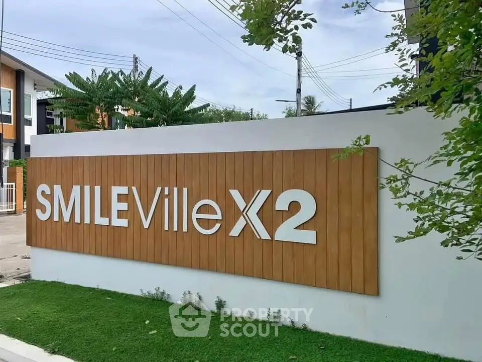 Modern real estate entrance with stylish signage at Smile Ville X2.